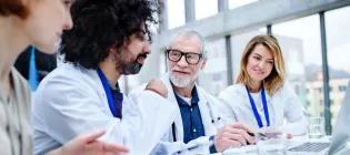 People in white laboratory coats talking