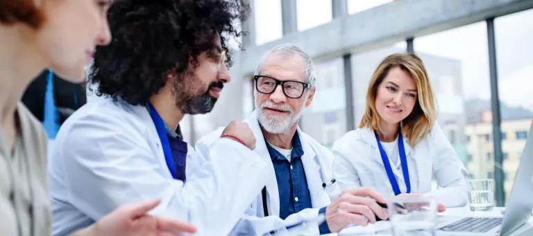 People in white laboratory coats talking